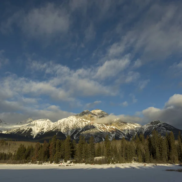 Frozen lake with mountain range in the background, Pyramid Lake, Highway 16, Jasper, Jasper National Park, Alberta, Canada