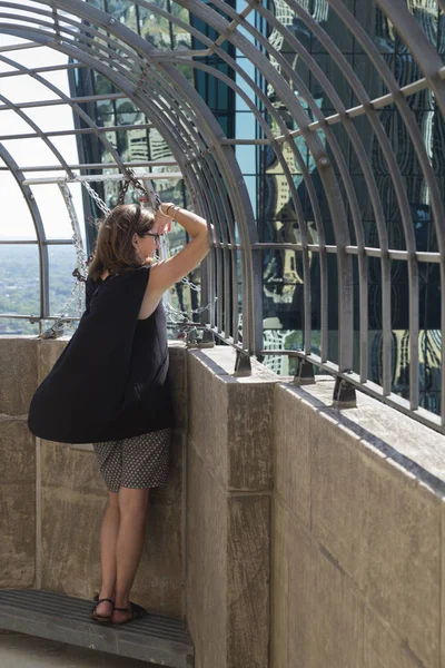 Woman looking at city view through railings, Minneapolis, Hennepin County, Minnesota, USA