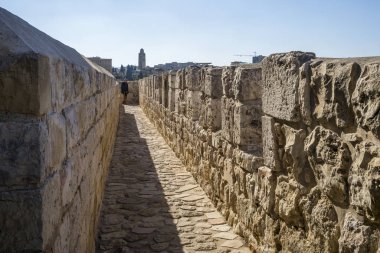 View of the wall promenade surrounding the Old City with YMCA tower in background, Jerusalem, Israel clipart