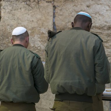Two army soldiers praying at the Western Wall, Old City, Jerusalem, Israel clipart