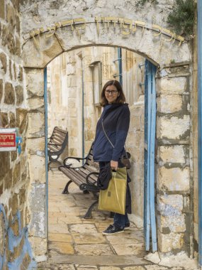 Happy woman standing in street, Safed, Northern District, Israel clipart