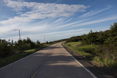 Empty road passing through rural landscape, Margaree Harbour, Cabot Trail, Cape Breton Island, Nova Scotia, Canada clipart
