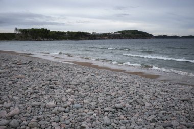 Scenic view of pebbles on beach, Cabot Trail, Cape Breton Island, Nova Scotia, Canada clipart
