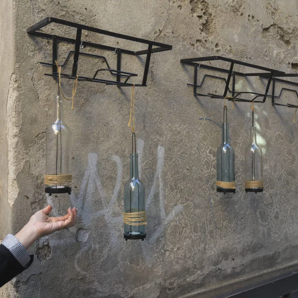 Decorative bottle lamps hanging on a wall, Orvieto, Terni Province, Umbria, Italy