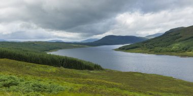 Scenic view of river flowing through mountains against cloudy sky, Scottish Highlands, Scotland clipart