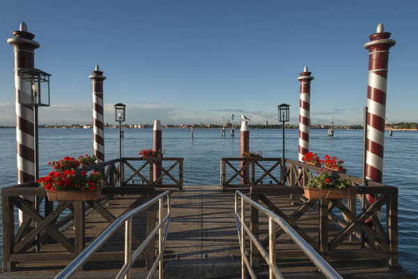 Mooring poles and pier in Venetian Lagoon, Cannaregio, Venice, Veneto, Italy