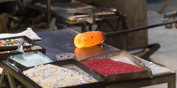 Close-up of glass being molded in factory, Murano, Venice, Veneto, Italy