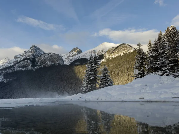 Lake with mountains in winter, Lake Louise, Banff National Park, Alberta, Canada