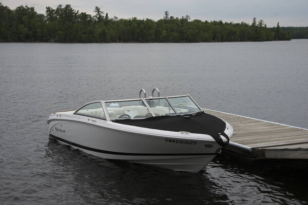 Boat moored at dock, Lake Of The Woods, Ontario, Canada