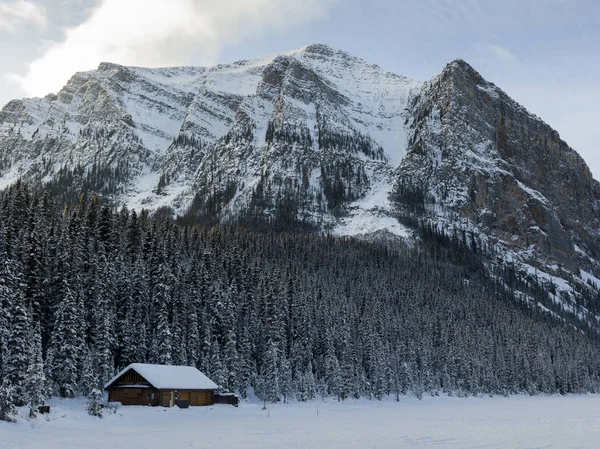 Lodge with mountains in winter snow, Lake Louise, Banff National Park, Alberta, Canada