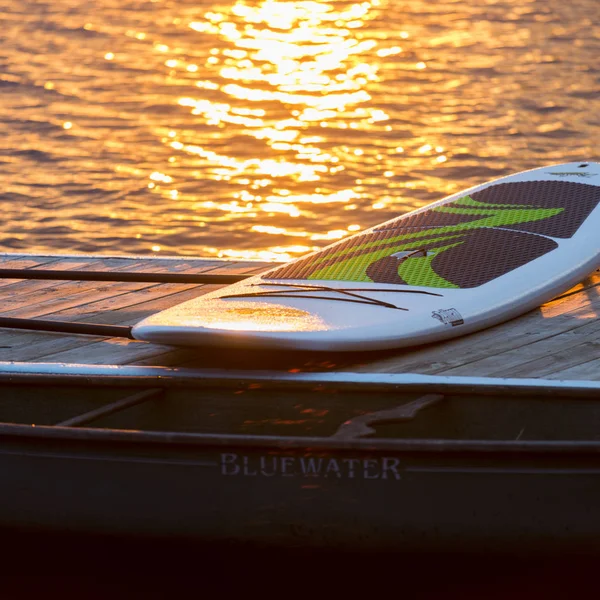 Paddleboard on the dock by the lake, Lake of The Woods, Ontario, Canada