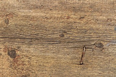 Düğümve paslı çekiçli çivi ile eski gri ve sarı ahşap doku
