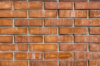 Fotoğrafta yeni bir tuğla duvar içinde kahverengi ton parçası yatay bir doku olduğunu