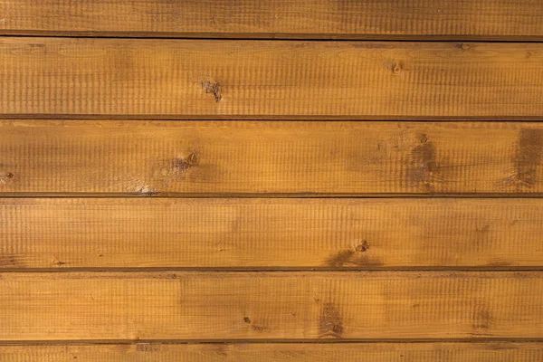 A horizontal texture of yellow boards with knots and resin painted with impregnation for wood Stock Picture