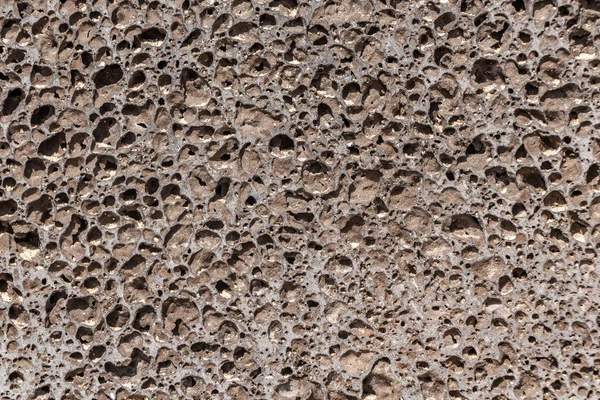 Hermosa textura de piedra naranja piedra pómez con agujeros está en la foto —  Fotos de Stock