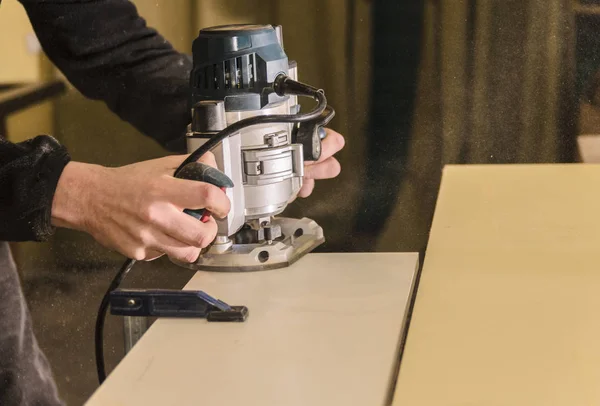 Craftsmans hands carefully controlling red Black Decker router on plank of  oak timber Stock Photo - Alamy