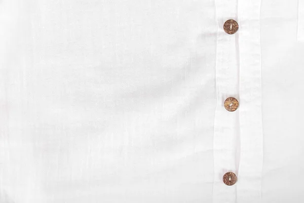 white casual shirt with the coconut shell button