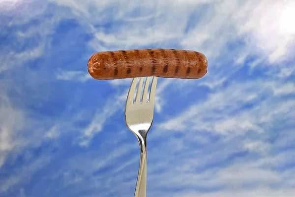 Grilled hot dog on fork — Stock Photo, Image