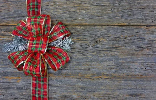 Red plaid Christmas bow on wood — Stock Photo, Image