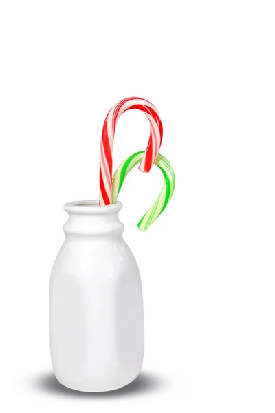 Christmas candy canes in retro milk bottle — Stock Photo, Image