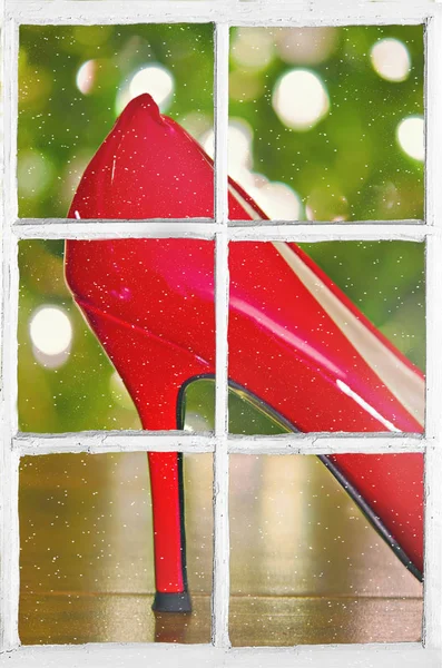 Red Christmas high heel shoe in window with snowflakes — Stock Photo, Image