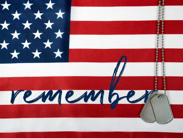 Word remember and dog tags on flag — Stock Photo, Image