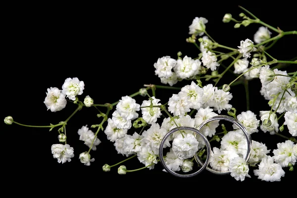 Wedding rings in baby's breath — Stock Photo, Image