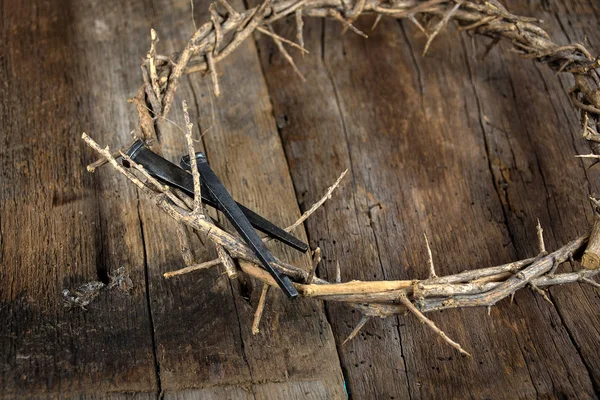 Crown of thorns and nails on wood — Stock Photo, Image