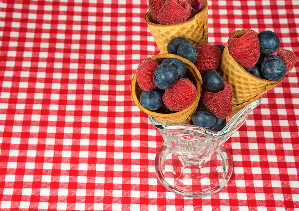 Raspberry and blueberry fruit in sugar cones — Stock Photo, Image