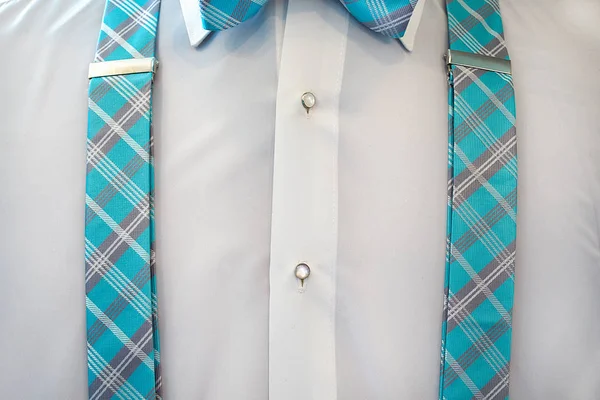 white tuxedo shirt with plaid suspenders