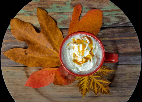Coffee with whipped cream on autumn leaf — Stock Photo, Image