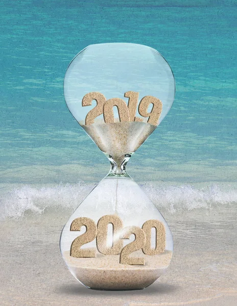 New Year 2020 hourglass on beach sand with tropical ocean background