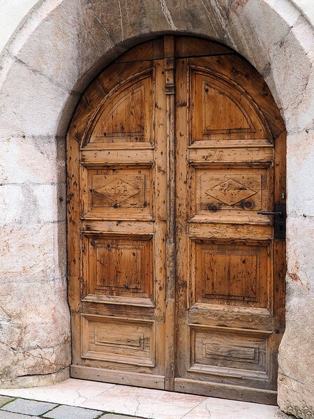 old wooden European door with arch design 