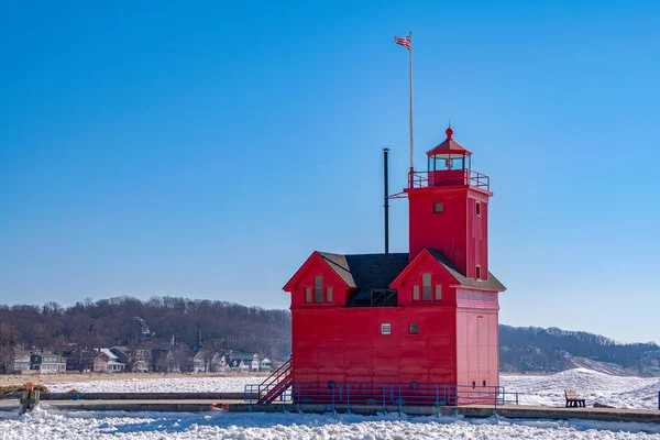 Big Red lighthouse in Holland Michigan harbor with ice in channel