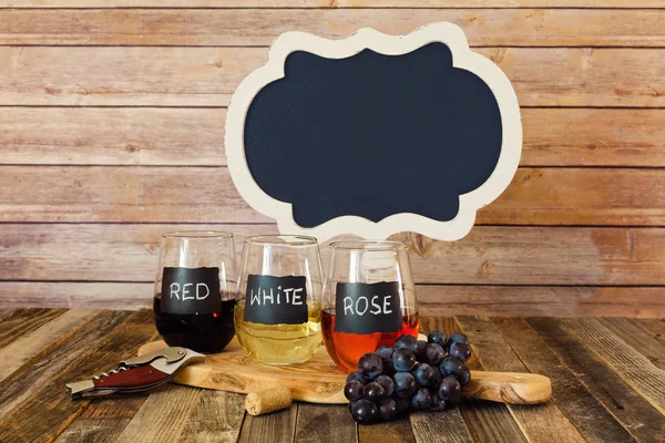 Three color wine flight in chalkboard glasses with a sign — Stock Photo, Image