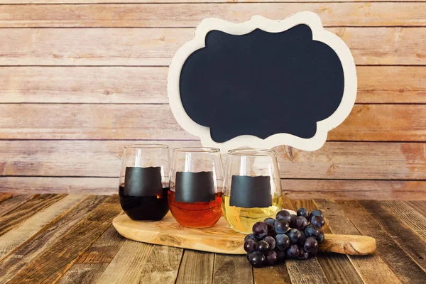 Three color wine flight in chalkboard glasses with a sign — Stock Photo, Image