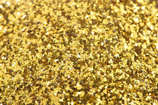 Background of gold sparkles, sweets, shiny gold texture. — Stock Photo, Image