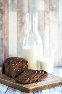 Kepekli ekmek tohumları ile ahşap bir tahta üzerine dilimlenmiş ve 