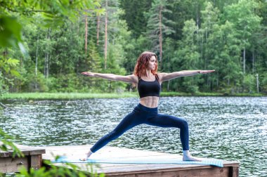 Yoga yapan genç bir Yogi kızı, Savaşçı 2 'de duruyor.