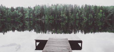 Empty pier of a beautiful lake.  Toned, atmospheric panoramic ph