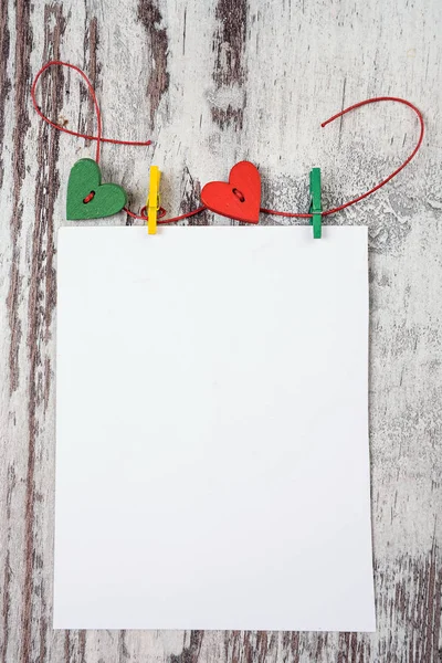 Empty notepad with hearts on wooden surface — Stock Photo, Image