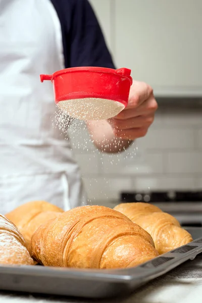 Powdered sugar on croissant — Stock Photo, Image