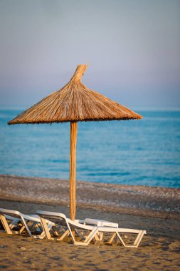 Sahilde saman bir şemsiye.