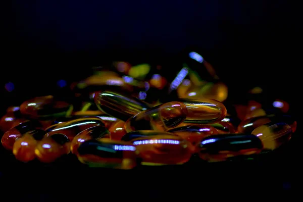 鳕鱼肝油欧米茄3维生素 e 凝胶胶囊在黑色背景下分离 — 图库照片