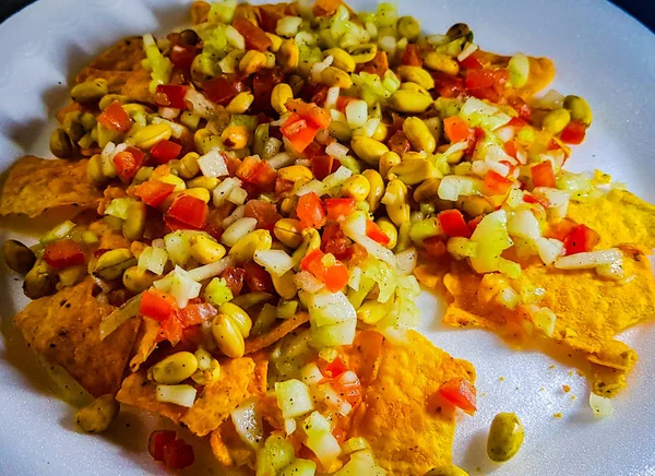 Spicy mixture of peanut tomato onion nacho cucumber — Stock Photo, Image