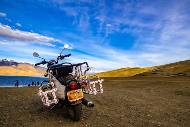 June 2016, Tsomoriri, Leh, India. A royal enfield motorbike along with tourist on the bank of lake Tsomoriri in the evening, Leh,India