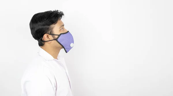 A male medical professional in white coat and mask in white background. view from right. concept image for viral infection precaution — Stockfoto