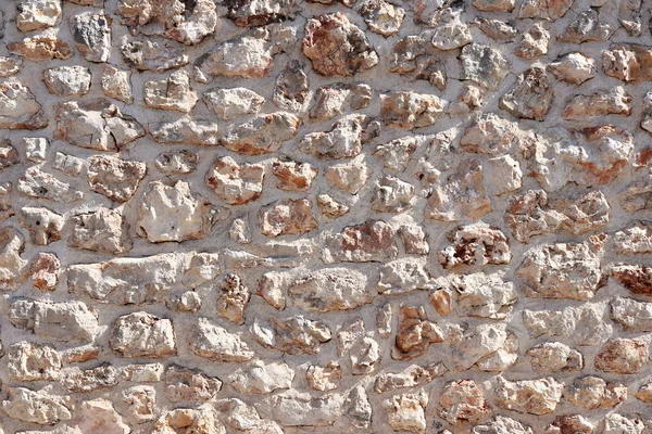 Antik Ortaçağ taş duvar. Doku duvar eski bir yapısının bir parçası. Tasarım ve yaratıcı çalışma için bir arka plan. Bina dış cephe süsleme ve dekorasyon. İnşaat işleri