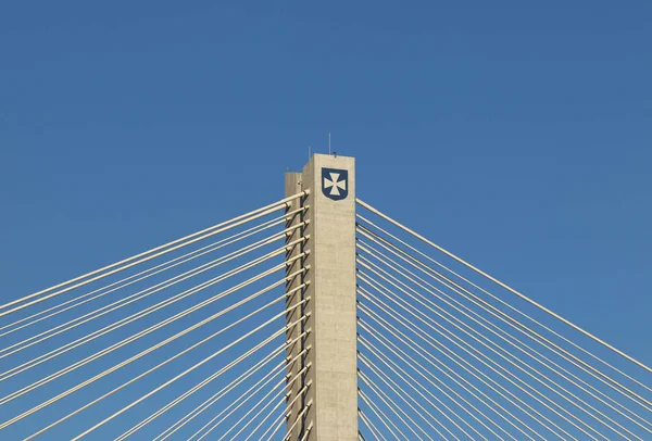 Rzeszow, Pologne - 9 9 2018 : Pont routier suspendu traversant la rivière Wislok. Construction métallique structure technologique. Architecture moderne. Une croix blanche sur fond bleu est un symbole de la ville — Photo