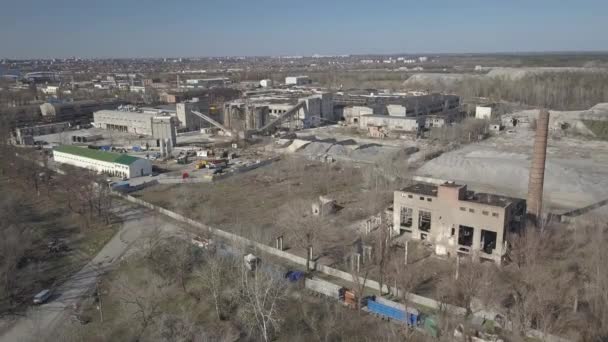 Production of crushed stone and bulk building materials. View of the quarry from a height. Aerial photography from a drone or quadrocopter. Panorama of construction work with the use of heavy equipmen — Stock Video